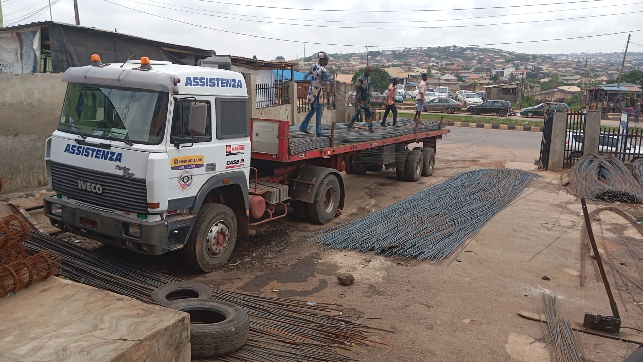 FOAK Iron House workers loading iron rods onto a delivery truck in Abeokuta